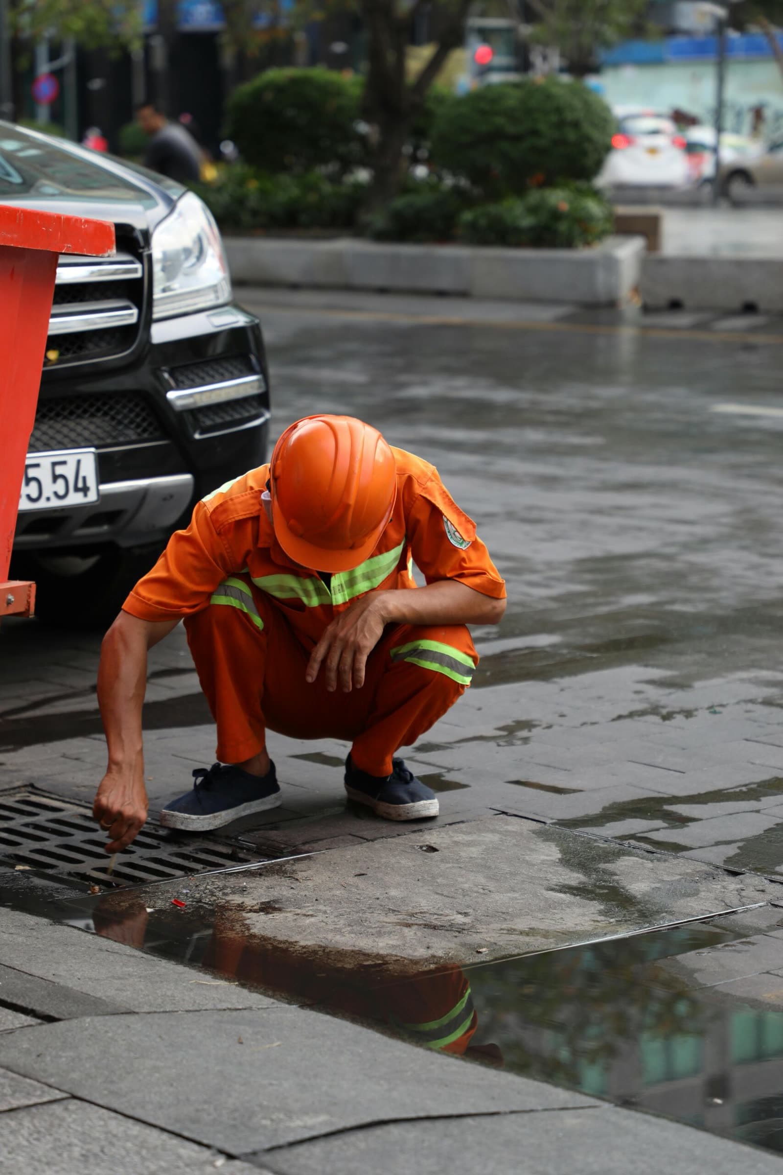 Drainage engineer inspecting an outdoor drain