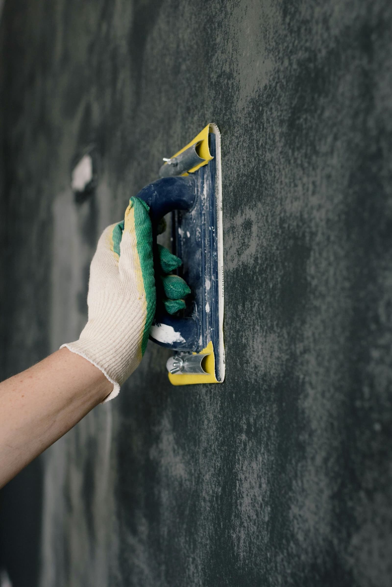 Plasterer smoothing a freshly skimmed wall